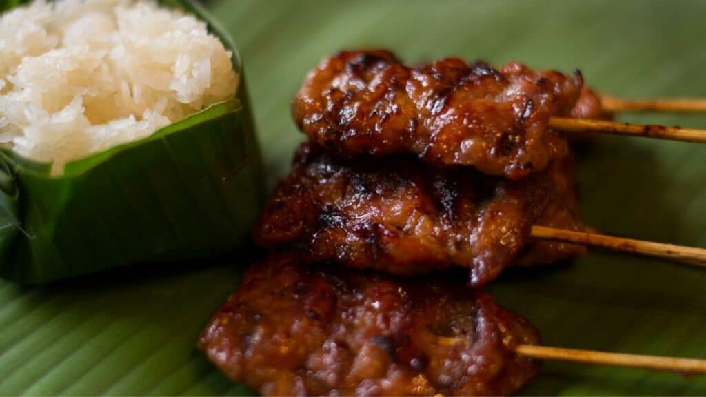Moo Ping are sticks with pork on them, often served with sticky rice and is a popular Thai street food dish