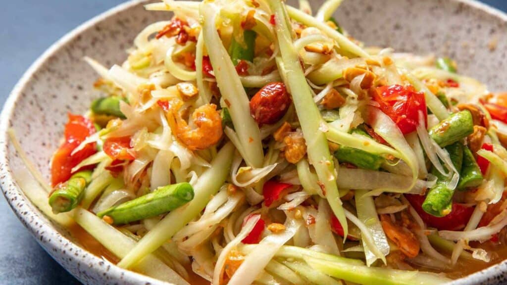 Plate with Som Tam, also known as green Papaya salad, which is a very popular Thai street food for the locals