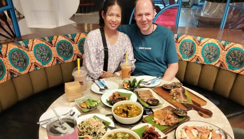 Chris and Saengduan eating food at a restaurant at Esplanade, Ratchada