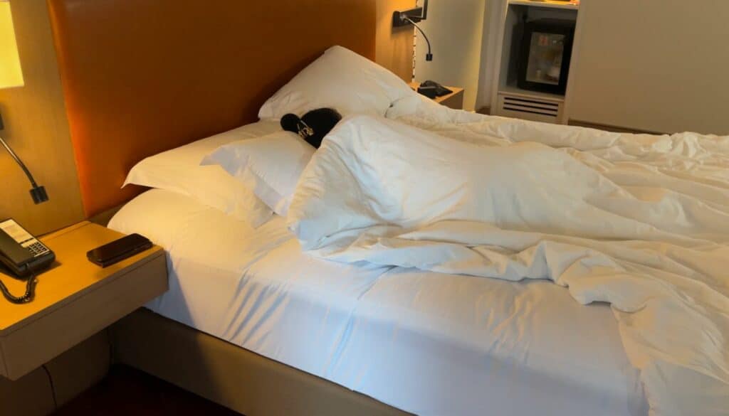Saengduan, a Thai woman sleeping in a big bed at the grand fortune hotel